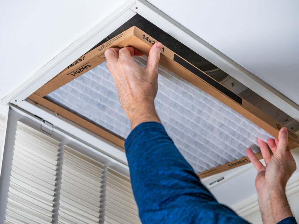 HVAC technician replacing a home air filter in Manteca