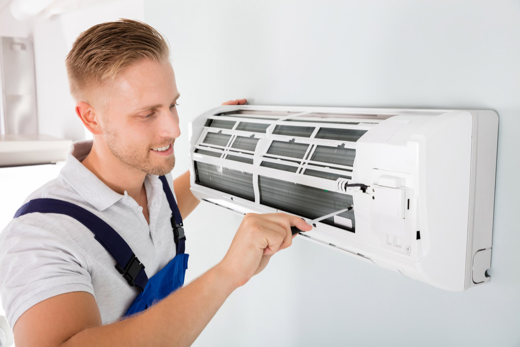 HVAC technician maintaining a ductless air conditioner in Manteca