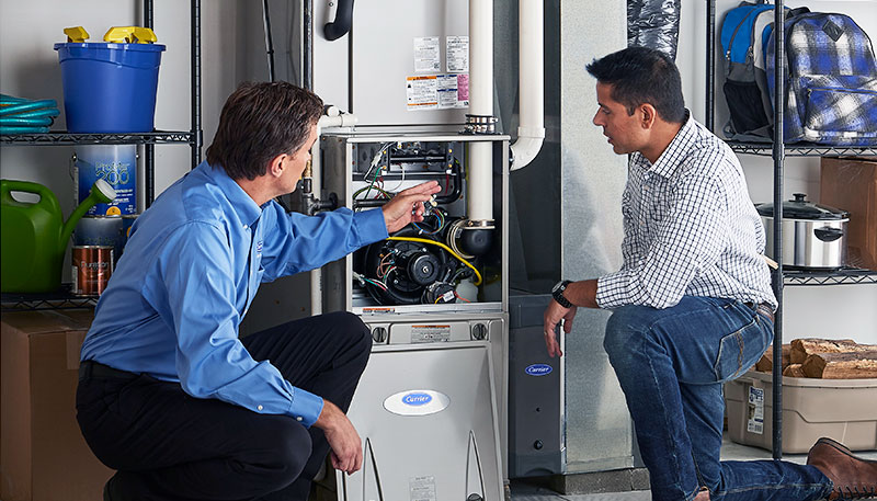 Technician evaluating a furnace for repair or replacement in Manteca