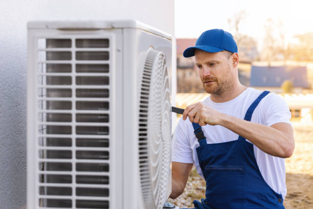 HVAC technician servicing an outdoor air conditioner in Manteca